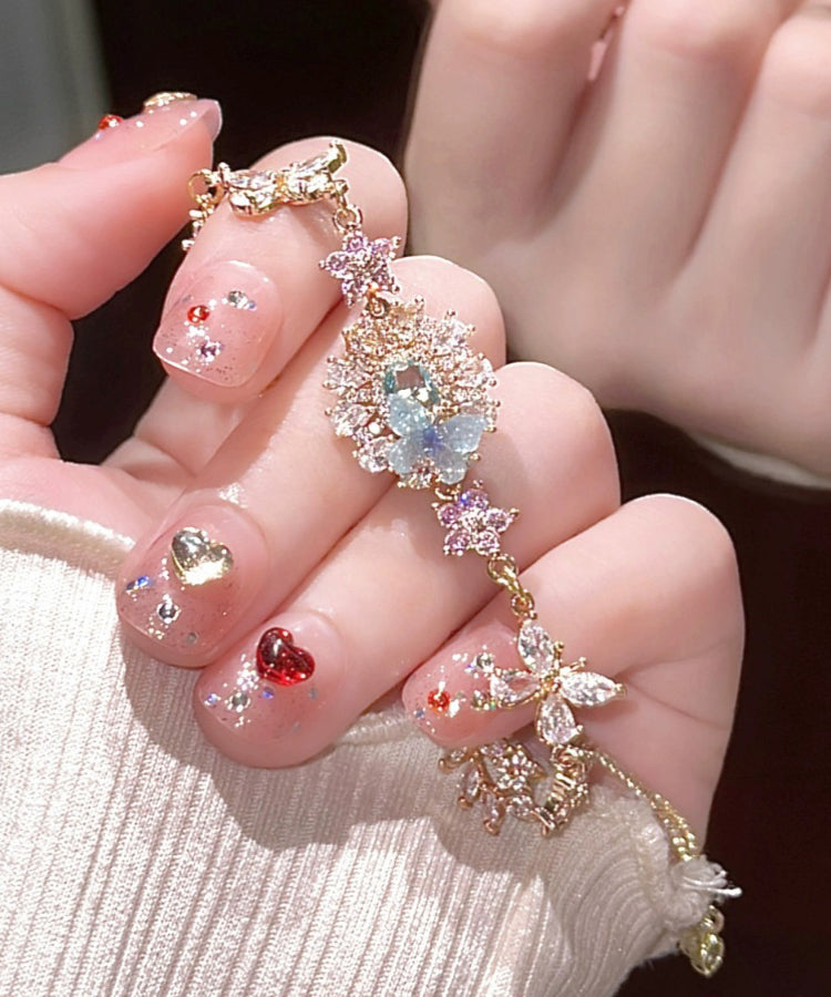 Pulsera con dije floral de mariposa y circonitas de cristal con bloques de color artísticos