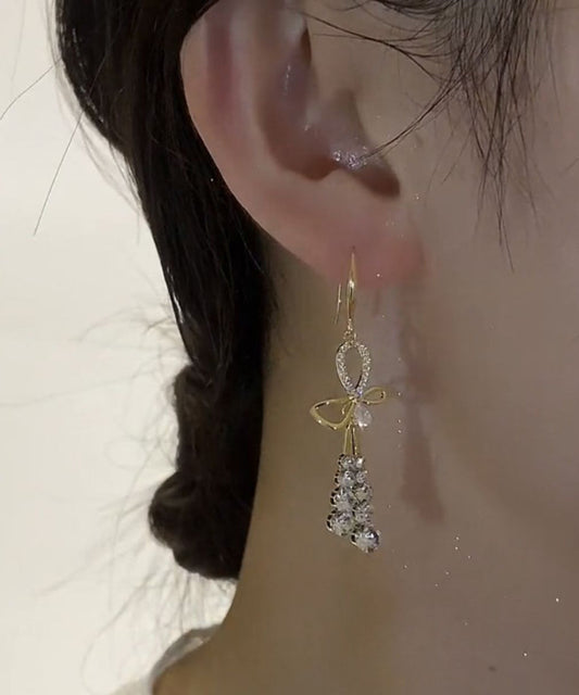 Hermosos aretes colgantes con borlas y lazo de circonitas doradas en plata esterlina