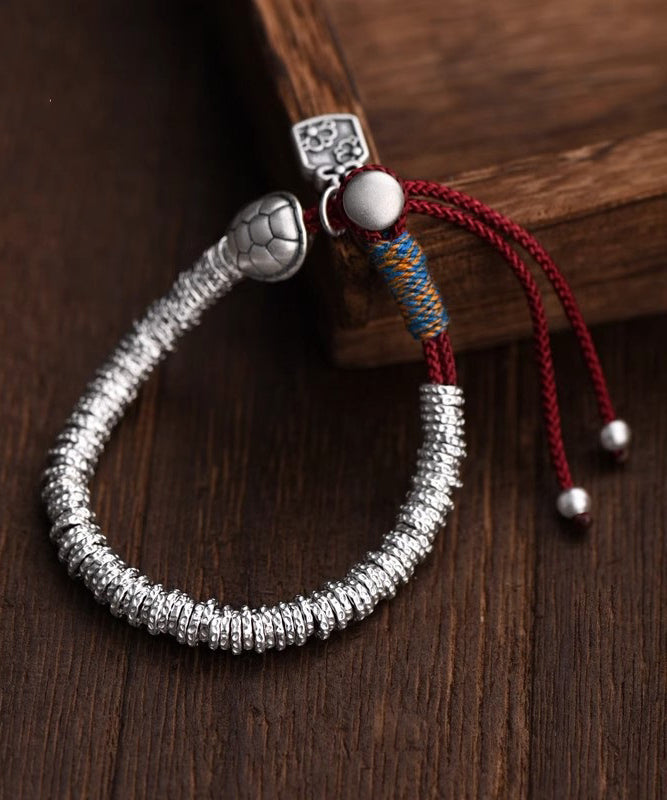 Pulsera de plata de ley con dijes de plata rota de seda boutique