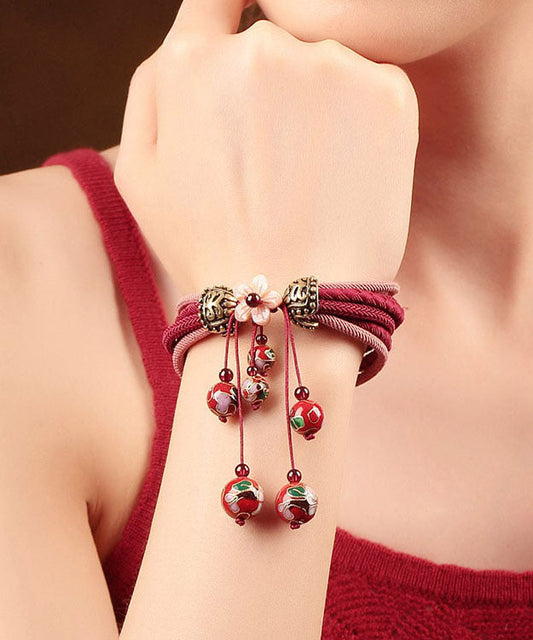 Elegante pulsera roja tejida a mano con aleación de cloisonné y flor de concha