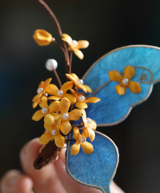 Horquilla de osmanthus con mariposa dorada de plata esterlina amarilla de estilo chino
