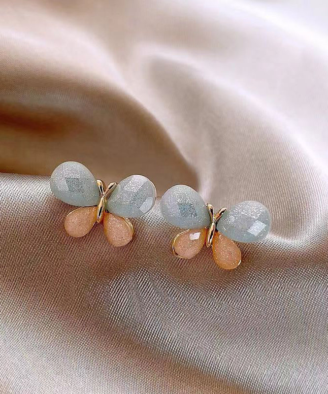 Pendientes de mariposa con diseño de bloques de color y dorado de cobre