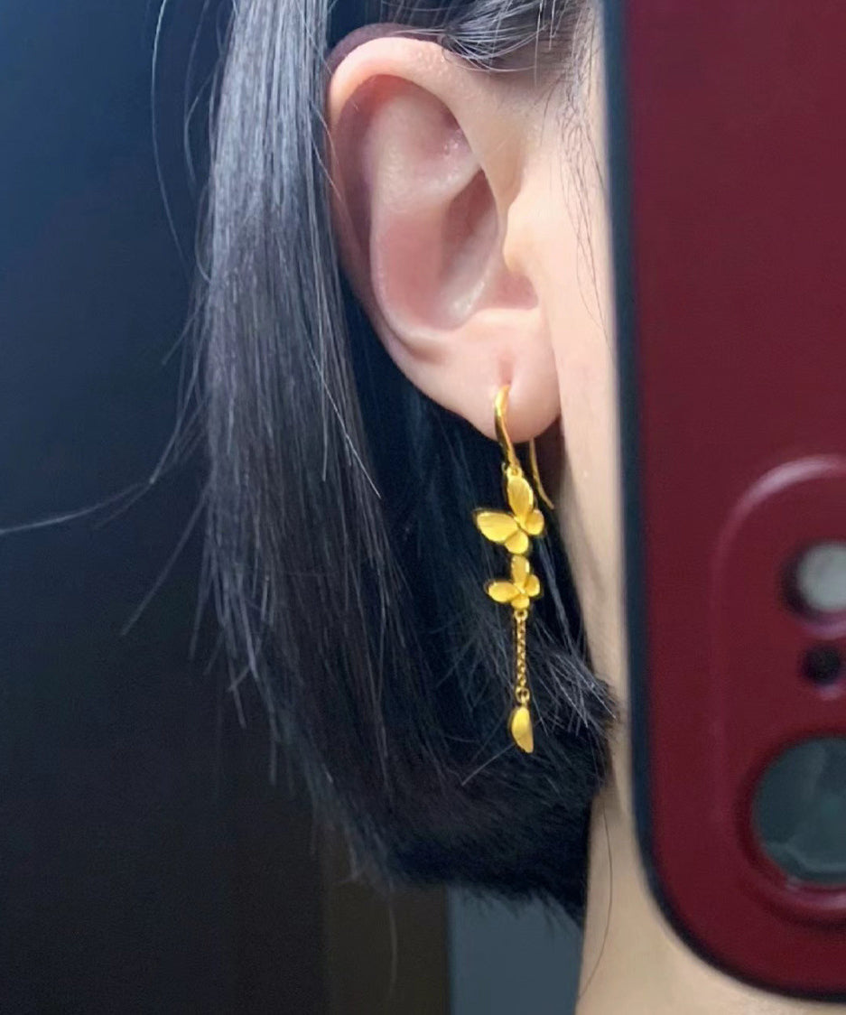 Elegante Ohrringe mit Schleife und Quaste in Goldlegierung