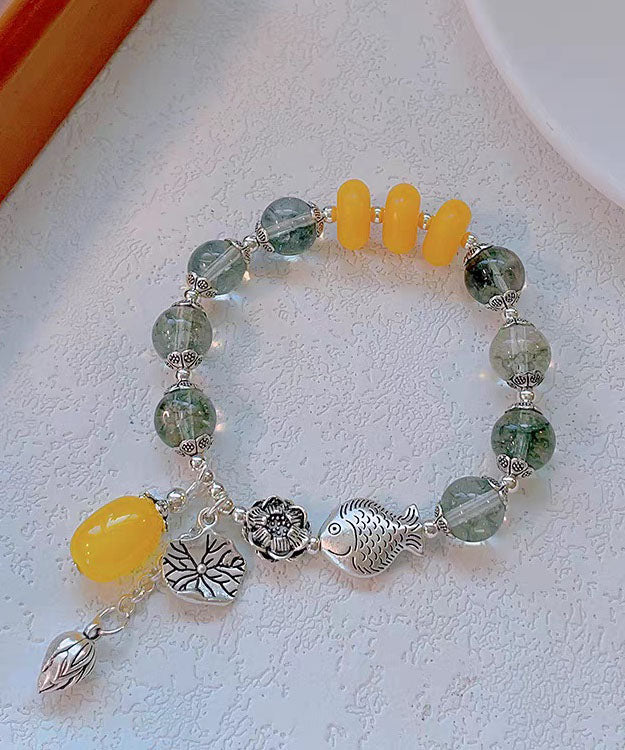 Modisches Bettelarmband aus Sterlingsilber mit Kristallen und kleinen Fischen, die mit einer Lotusblüte spielen