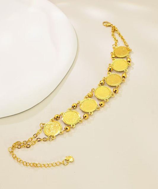 Doppellagiges Armband mit Münzanhänger aus feinem Gold und Sterlingsilber mit Übergoldung.