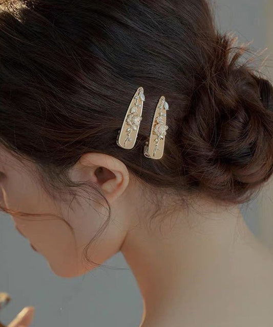 Par de horquillas francesas de aleación dorada con diseño floral de perlas