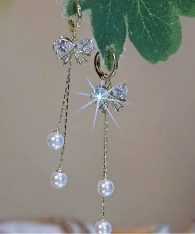 Pendientes delgados de plata de ley dorada con borlas y lazo de perla y circonitas doradas