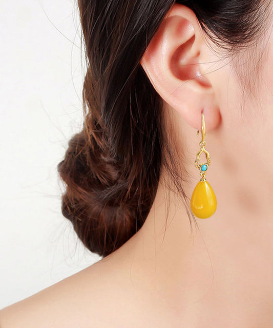 Elegantes pendientes colgantes de cera de abeja con incrustaciones de oro antiguo y plata de ley amarilla