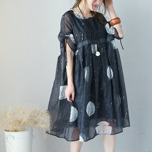Modisches, schwarzes, langes Chiffonkleid mit Prints. Locker sitzendes Chiffonkleid mit hoher Taille und feinen Kaftanen mit Kordelzug an den Ärmeln.