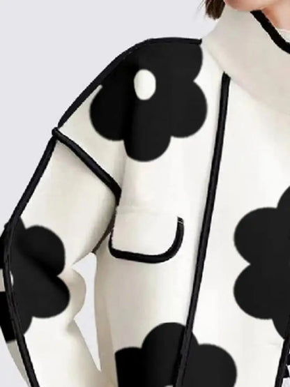 Black and white floral print top with contrasting trim and loose fit
