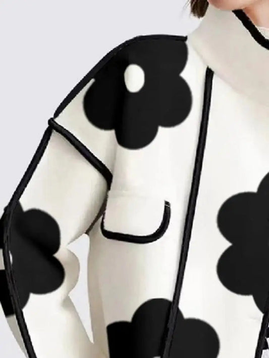 Black and white floral print top with contrasting trim and loose fit