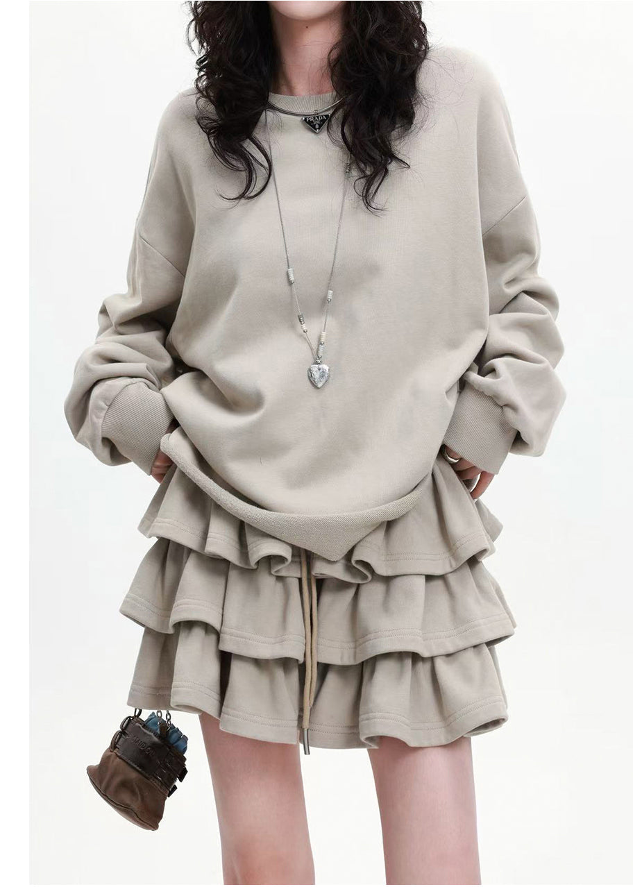 Aprikosenfarbenes, lockeres Baumwoll-Zweiteiler-Set mit Lagenrock und Rüschen für den Frühling