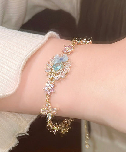 Pulsera con dije floral de mariposa y circonitas de cristal con bloques de color artísticos