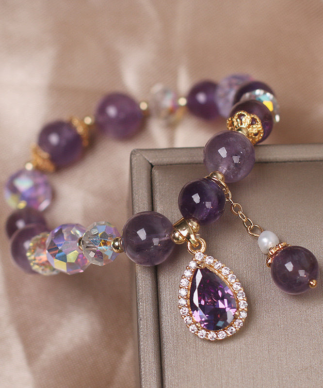 Pulsera con dije de amor de circonita y cuentas de cristal morado