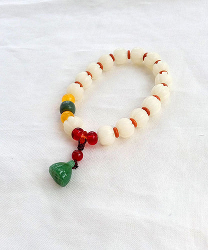 Pulsera con dijes de ágata esmaltada coloreada y calcedonia de raíz de bodhi blanca