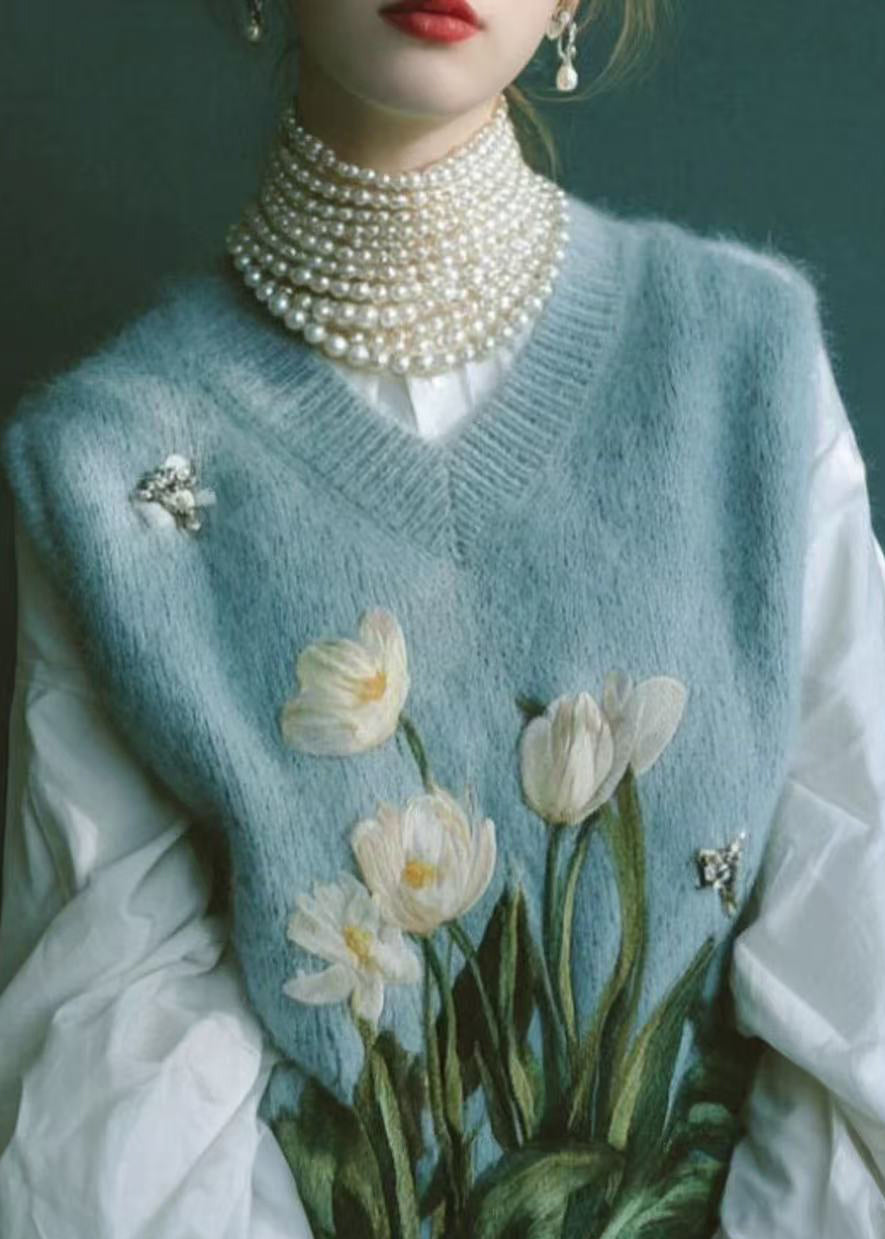 Hermoso chaleco de punto bordado con cuello en V azul sin mangas