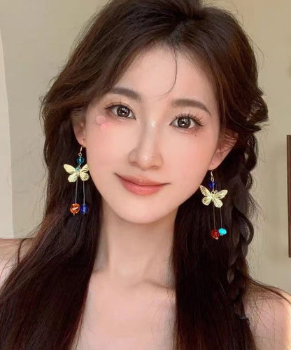 Hermosos aretes colgantes con borlas y cuentas de mariposa de aleación con bloques de color