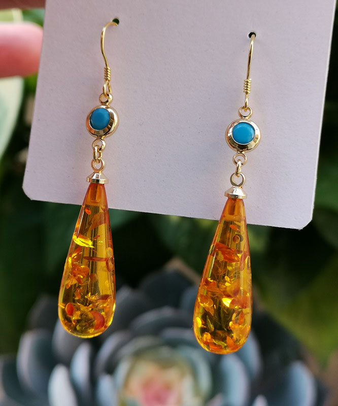 Hermosos aretes colgantes de ámbar naranja con forma de gota de agua