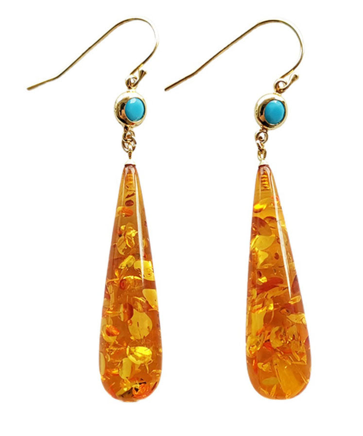Hermosos aretes colgantes de ámbar naranja con forma de gota de agua