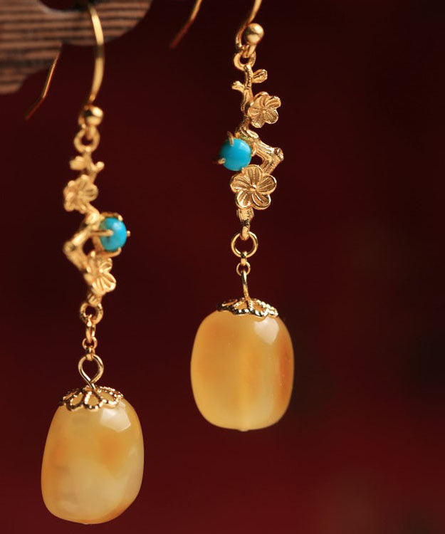 Hermosos aretes colgantes de turquesa y cera de abejas en plata de ley naranja y oro antiguo.