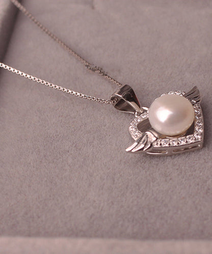 Hermoso collar con colgante de circonita y perla dorada en plata de ley rosa