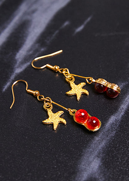 Hermosos aretes colgantes de estrella de mar con gema roja en oro de 14 quilates