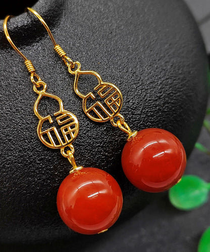 Hermosos aretes colgantes con diseño gráfico de ágata dorada en plata de ley roja