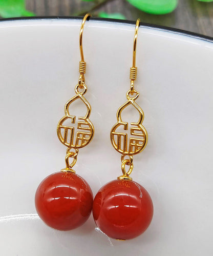 Hermosos aretes colgantes con diseño gráfico de ágata dorada en plata de ley roja