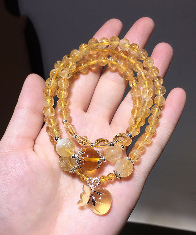 Hermosa pulsera con dijes de rosario de cristal amarillo de múltiples vueltas