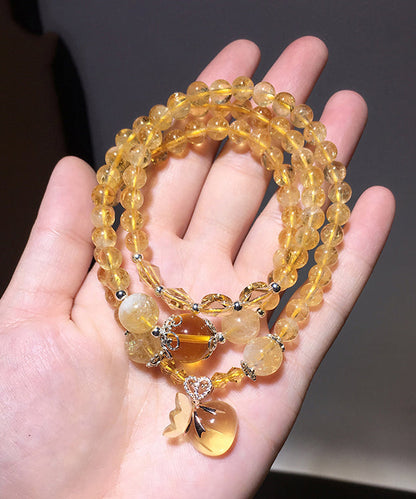 Hermosa pulsera con dijes de rosario de cristal amarillo de múltiples vueltas