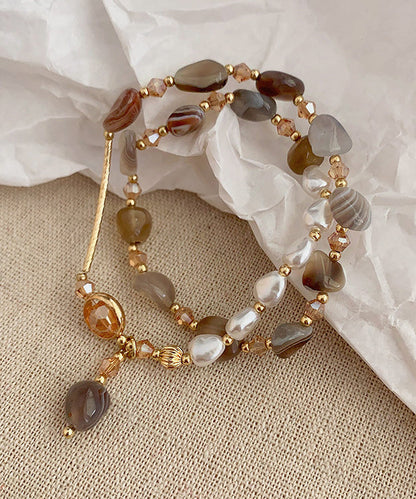 Pulsera Bohemia con múltiples cuentas de cobre dorado y perla de cristal