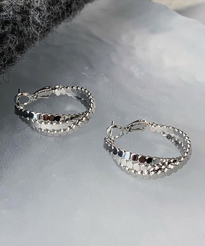 Pendientes de aro con diseño de masa frita en plata de ley y seda de boutique