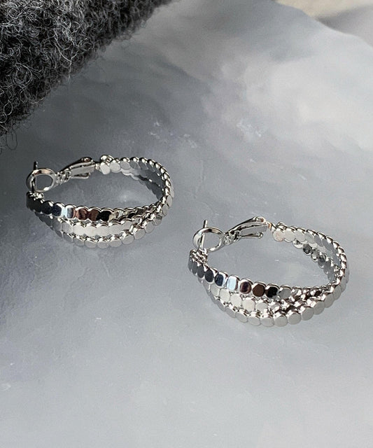 Pendientes de aro con diseño de masa frita en plata de ley y seda de boutique