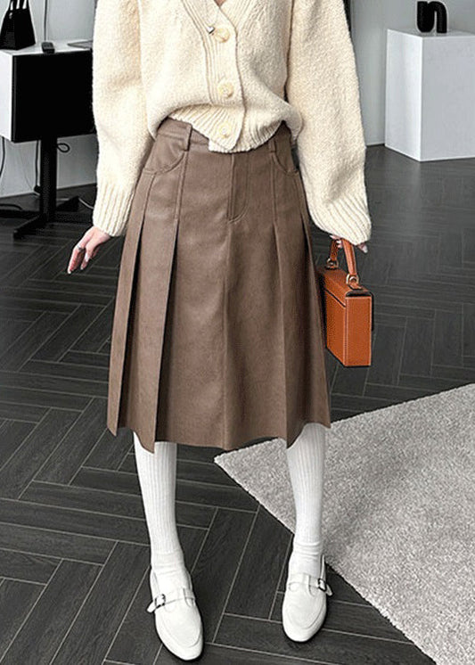 Brauner, hochtaillierter Faltenrock aus Kunstleder mit Knöpfen und Taschen