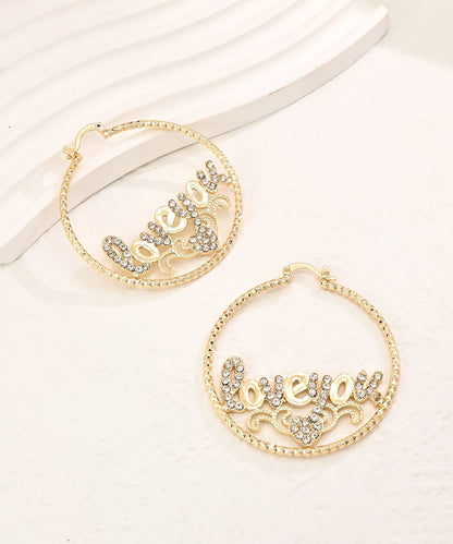Pendientes de aro con diseño gráfico de circonitas doradas informales