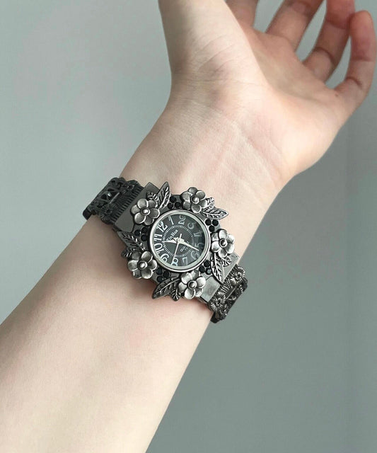 Elegantes relojes de aleación negra con flores en relieve
