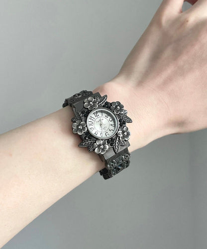 Elegantes relojes de aleación negra con flores en relieve