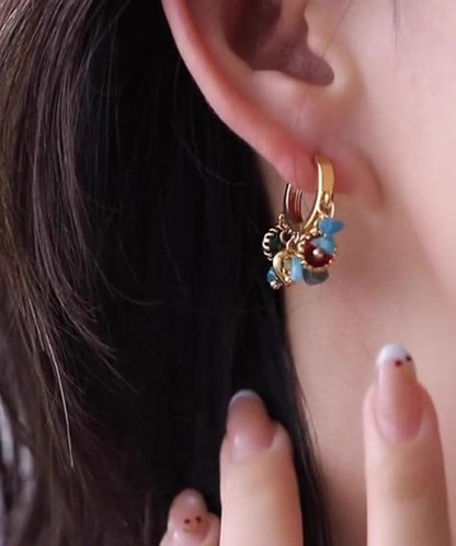 Elegante asymmetrische Creolen aus Naturstein mit blau-kupferfarbener Übergoldung und Übergoldung.