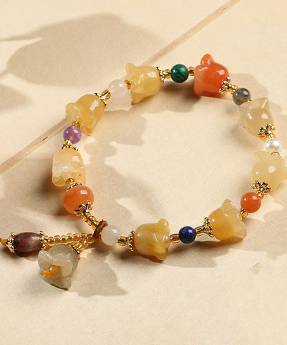 Schickes Charm-Armband „Lilie der Ringe“ aus goldener Seide und Jade