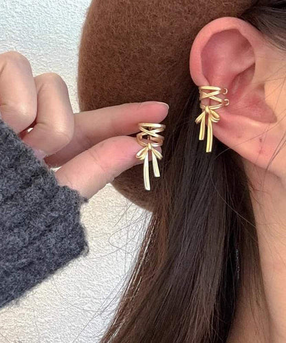 Pendientes de aro con lazo dorado de metal y seda elegantes