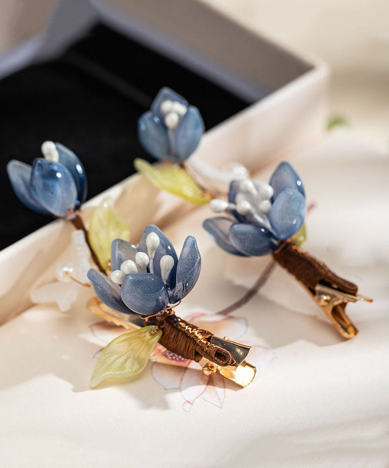 Par de horquillas de estilo chino con forma de loto, esmaltadas en color perla y cobre azul dorado