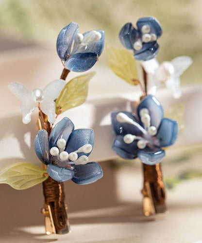 Par de horquillas de estilo chino con forma de loto, esmaltadas en color perla y cobre azul dorado
