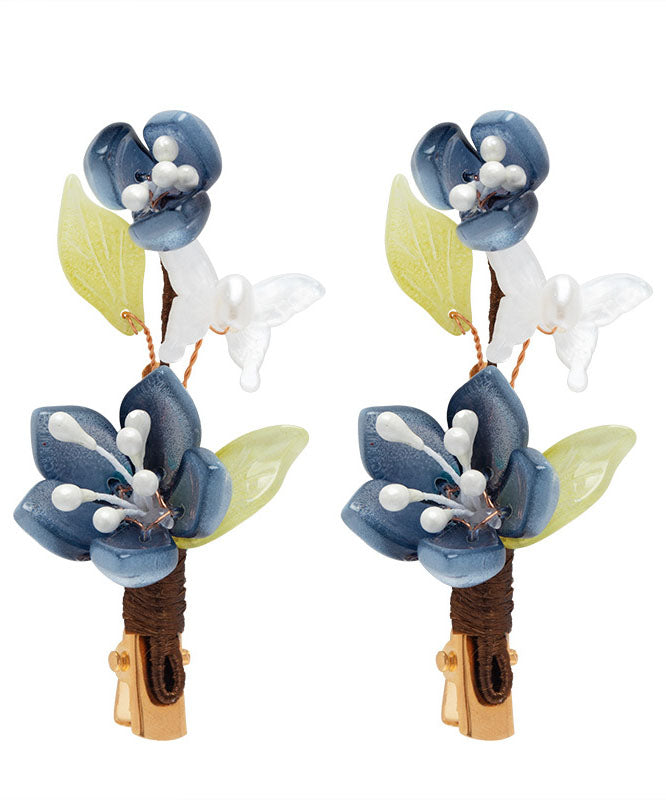 Par de horquillas de estilo chino con forma de loto, esmaltadas en color perla y cobre azul dorado