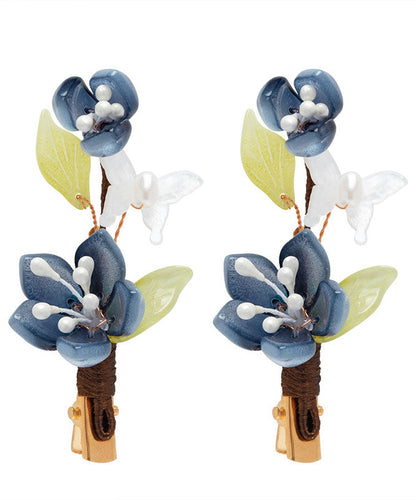 Par de horquillas de estilo chino con forma de loto, esmaltadas en color perla y cobre azul dorado