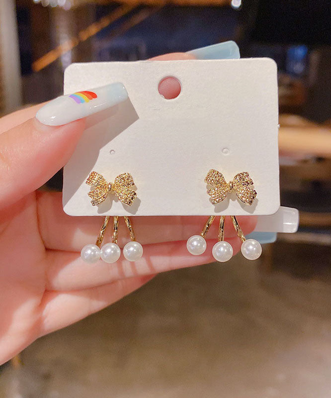 Pendientes elegantes con lazo de circonita y perla en plata de ley y oro