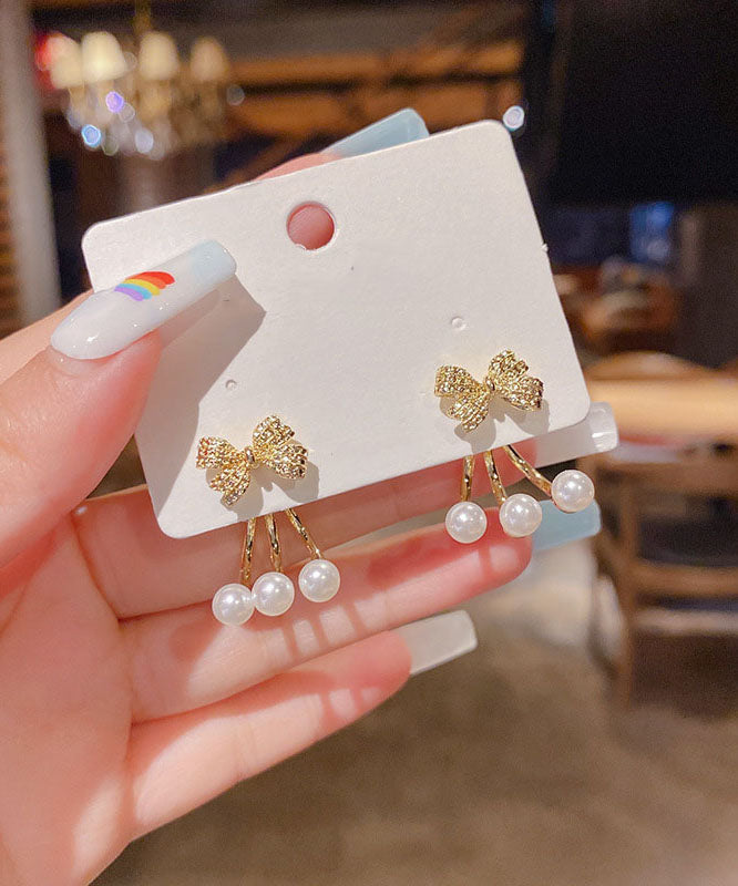 Pendientes elegantes con lazo de circonita y perla en plata de ley y oro