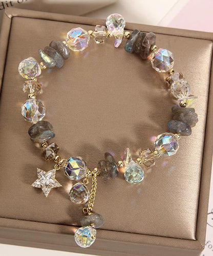 Pulsera elegante de plata de ley con dije de circonitas y cristales dorados en color morado claro