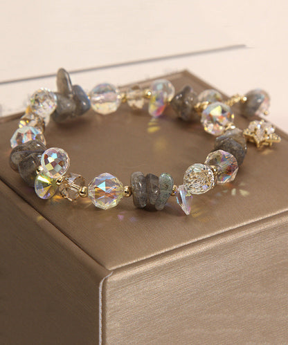 Pulsera elegante de plata de ley con dije de circonitas y cristales dorados en color morado claro