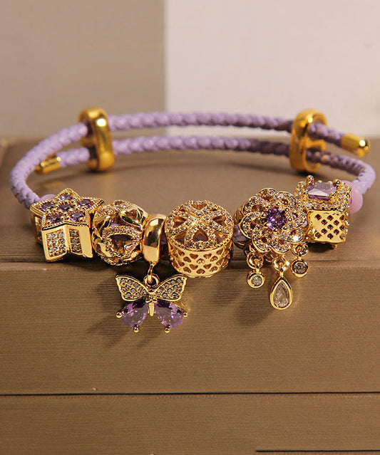 Pulsera elegante de plata de ley morada con circonitas doradas, mariposa, estrella y gota de agua