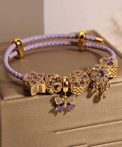 Pulsera elegante de plata de ley morada con circonitas doradas, mariposa, estrella y gota de agua